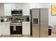 Bright kitchen featuring stainless steel appliances and white cabinetry at 17099 Carleen Ave, Port Charlotte, FL 33948