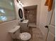 Bathroom featuring tiled shower, toilet, vanity, mirror, and great lighting at 1906 E 98Th Ave, Tampa, FL 33612