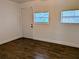 Bedroom featuring tile flooring and two windows at 1906 E 98Th Ave, Tampa, FL 33612