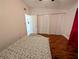 Bedroom featuring tile flooring, white closets, red curtains, and neutral paint at 1906 E 98Th Ave, Tampa, FL 33612