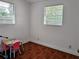 Bedroom with tile flooring, table, and two windows at 1906 E 98Th Ave, Tampa, FL 33612