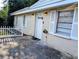 Charming home with a decorative door, white shutters, and a quaint picket fence at 1906 E 98Th Ave, Tampa, FL 33612