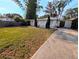 Inviting home with manicured front yard, white picket fence, and charming curb appeal at 1906 E 98Th Ave, Tampa, FL 33612