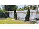 Charming home featuring a welcoming entrance, a well-manicured lawn, and white picket fence at 1906 E 98Th Ave, Tampa, FL 33612