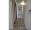 Hallway featuring tiled floors, closet, and doorway at 1906 E 98Th Ave, Tampa, FL 33612