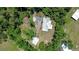 An aerial view of the house shows the architectural features and the beautiful treed surroundings at 1931 Jaudon Rd, Dover, FL 33527