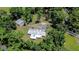 An aerial view showing the roof and the expansive surrounding green space and mature trees at 1931 Jaudon Rd, Dover, FL 33527