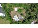A bird's eye view of a home surrounded by lush greenery and mature trees at 1931 Jaudon Rd, Dover, FL 33527