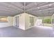 The open back porch has grey painted floors and roof at 1931 Jaudon Rd, Dover, FL 33527