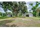 Large backyard featuring detached building with glass block windows surrounded by mature trees at 1931 Jaudon Rd, Dover, FL 33527