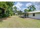 The backyard featuring a covered patio, perfect for outdoor relaxation and entertainment at 1931 Jaudon Rd, Dover, FL 33527
