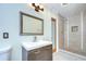 Modern bathroom features a wooden vanity and tiled shower at 1931 Jaudon Rd, Dover, FL 33527