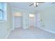 Bedroom featuring an open floor plan, two closets, light tile floor, and ensuite bathroom at 1931 Jaudon Rd, Dover, FL 33527