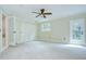 A spacious bedroom with a ceiling fan, closet, back door, and access to the primary bath at 1931 Jaudon Rd, Dover, FL 33527