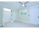 Bright bedroom features tiled floors, closet, and paneled door at 1931 Jaudon Rd, Dover, FL 33527