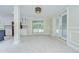 An open dining area with light tile flooring, a white breakfast bar, and sliding doors to screened porch at 1931 Jaudon Rd, Dover, FL 33527