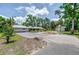 Well-maintained single-story home with mature landscaping and a spacious driveway and outbuilding at 1931 Jaudon Rd, Dover, FL 33527