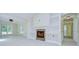 Bright living room featuring a stone fireplace, built-in shelving, and tiled flooring at 1931 Jaudon Rd, Dover, FL 33527