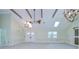 A spacious living room with vaulted ceilings and a chandelier at 1931 Jaudon Rd, Dover, FL 33527