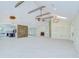 Spacious living room featuring a stone accent wall, fireplace, and wood-beam vaulted ceiling at 1931 Jaudon Rd, Dover, FL 33527