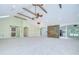Open-concept living room with stone accent wall, fireplace, wood beams, and tile floors at 1931 Jaudon Rd, Dover, FL 33527