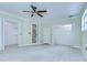 An open main bedroom featuring large closets, ensuite bathroom, and light tile flooring at 1931 Jaudon Rd, Dover, FL 33527