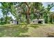 The well-manicured yard with mature trees and 2 sheds provide ample storage and adds aesthetic appeal at 1931 Jaudon Rd, Dover, FL 33527