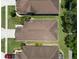 Overhead view of the house showcasing its roof, surrounding lawn, and neighboring properties at 26501 Whirlaway Ter, Wesley Chapel, FL 33544