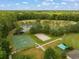 Aerial view showing the tennis and basketball courts with recreation area, surrounded by lush landscaping at 26501 Whirlaway Ter, Wesley Chapel, FL 33544