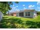 A well-maintained backyard features a green lawn and screened-in lanai, perfect for enjoying the outdoors at 26501 Whirlaway Ter, Wesley Chapel, FL 33544