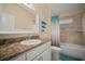 Well-lit bathroom features a shower-tub combo with decorative tile and a single sink vanity at 26501 Whirlaway Ter, Wesley Chapel, FL 33544