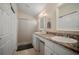 Double sink bathroom with a frosted glass walk-in shower and vanity space at 26501 Whirlaway Ter, Wesley Chapel, FL 33544