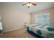 Comfortable carpeted bedroom with ceiling fan and natural light from the window at 26501 Whirlaway Ter, Wesley Chapel, FL 33544