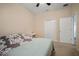 Comfortable bedroom with ceiling fan, closet, and stylish bed with modern bedding at 26501 Whirlaway Ter, Wesley Chapel, FL 33544