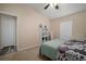 Cozy bedroom with ceiling fan, comfortable bed with stylish bedding and neutral decor at 26501 Whirlaway Ter, Wesley Chapel, FL 33544