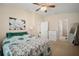 Spacious bedroom with ceiling fan features carpet and view of an ensuite bathroom at 26501 Whirlaway Ter, Wesley Chapel, FL 33544