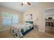 Bright bedroom with carpet flooring features natural light and a view into the kitchen at 26501 Whirlaway Ter, Wesley Chapel, FL 33544