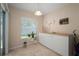 Cozy breakfast nook with a large window, indoor plants, and a modern wine rack at 26501 Whirlaway Ter, Wesley Chapel, FL 33544
