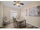 Dining room features neutral colors and contemporary flower art pieces on the wall at 26501 Whirlaway Ter, Wesley Chapel, FL 33544