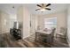 Cozy dining area features wood-look floors, and a modern ceiling fan light fixture at 26501 Whirlaway Ter, Wesley Chapel, FL 33544