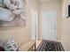 A home entryway featuring neutral walls, patterned rug, and bench with decorative pillows at 26501 Whirlaway Ter, Wesley Chapel, FL 33544
