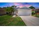 Charming single-Gathering home featuring a well-maintained lawn, two-car garage and inviting curb appeal at 26501 Whirlaway Ter, Wesley Chapel, FL 33544
