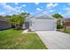 Charming single-story home featuring a well-maintained lawn and attached two-car garage at 26501 Whirlaway Ter, Wesley Chapel, FL 33544