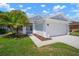 Charming single-story home with a well-manicured lawn, mature landscaping, and a two-car garage at 26501 Whirlaway Ter, Wesley Chapel, FL 33544