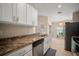 Bright kitchen with white cabinetry and granite countertops and stainless steel appliances at 26501 Whirlaway Ter, Wesley Chapel, FL 33544