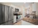 Kitchen features stainless steel appliances, granite countertops, and white cabinets at 26501 Whirlaway Ter, Wesley Chapel, FL 33544