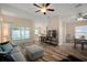 Bright living room with sliding glass doors to the backyard and an open layout at 26501 Whirlaway Ter, Wesley Chapel, FL 33544