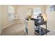 Home office with a black desk, white shelving unit, and a comfortable chair at 26501 Whirlaway Ter, Wesley Chapel, FL 33544