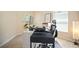 Bright home office with a standup desk, white shelving, and comfortable ergonomic chair at 26501 Whirlaway Ter, Wesley Chapel, FL 33544