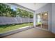 This screened-in lanai offers a view of the green backyard and access to the interior through sliding glass doors at 26501 Whirlaway Ter, Wesley Chapel, FL 33544